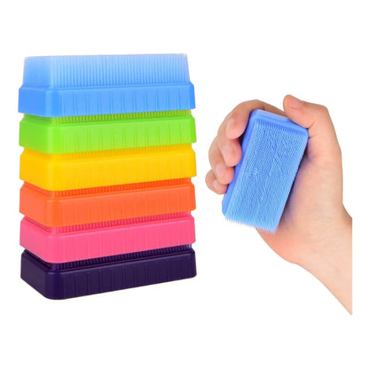Stack of colorful sensory brushes and a hand holding one blue tactile brush