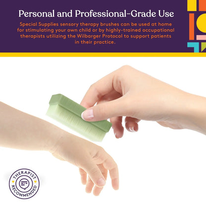 Hand using green sensory therapy brush on child's arm, therapist recommended, sensory tool