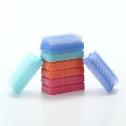 Stack of colorful sensory brushes for tactile stimulation on white background