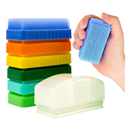 Stack of colorful sensory brushes for tactile therapy, with hand holding blue brush
