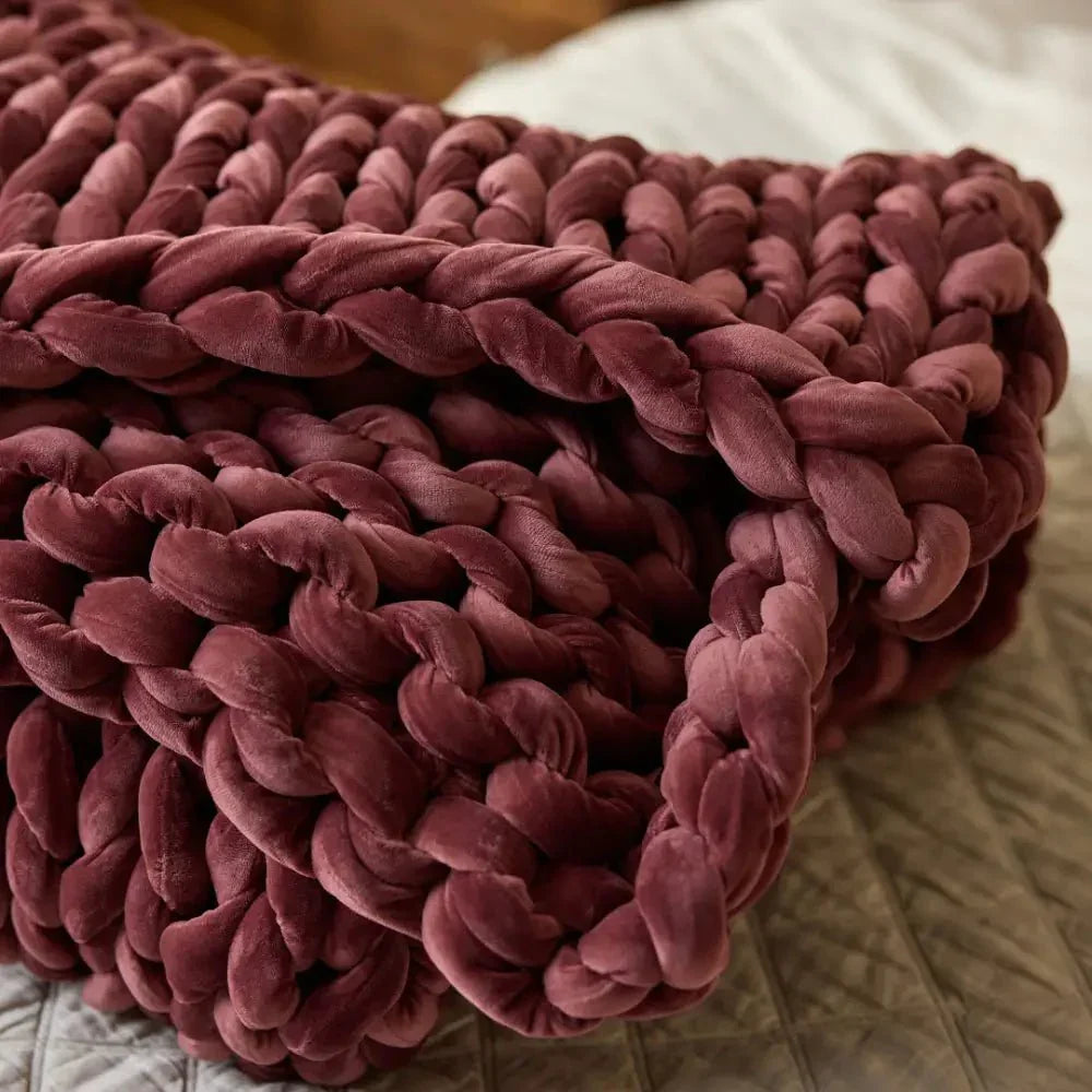 Chunky ruby velvet weighted blanket on a bed, ideal for sensory and sleep support