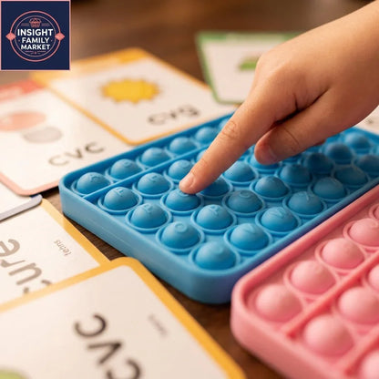 Child using tactile pop it letter board with CVC word cards for sensory literacy learning